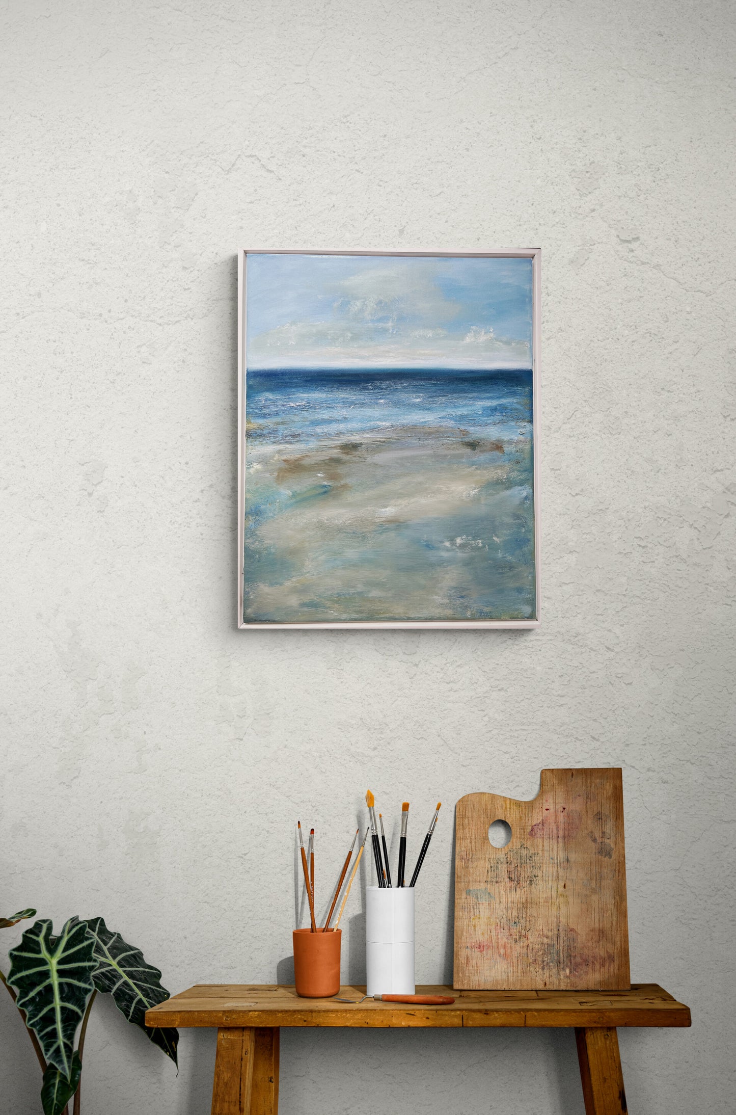 art oil on canvas board seascape ocean artwotk modern painting
with floater frame dark blues and neutral beach tones art wit sky and cloud waves at low tide room mockup