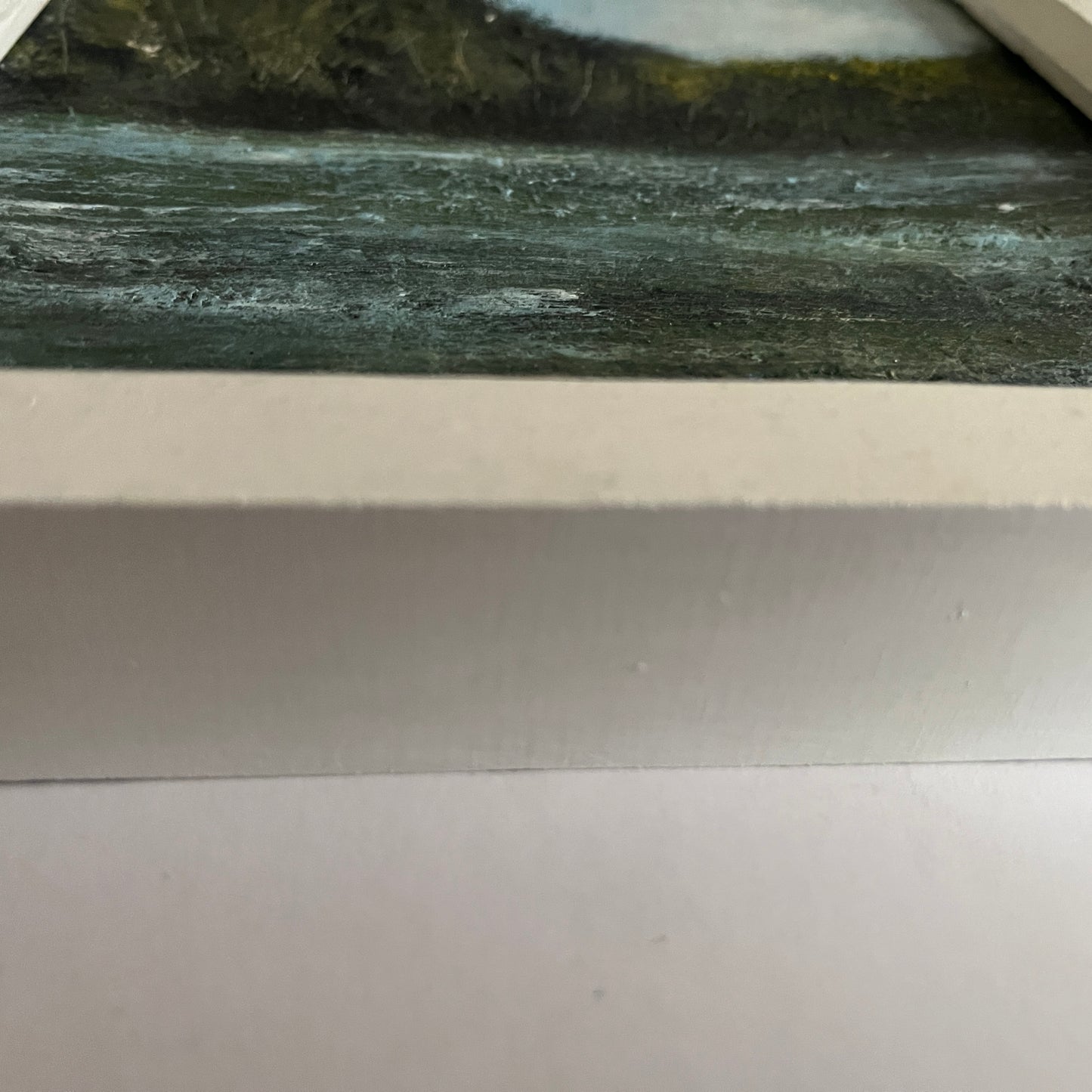 Close-up of a river with water flowing, surrounded by greenery. framed oil painting of river and trees and birds in a white wooden frame
